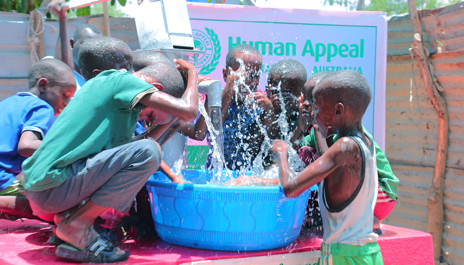 Community members gathered at a newly installed clean water well